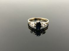 A 9ct gold sapphire and diamond ring, size R. CONDITION REPORT: 2.