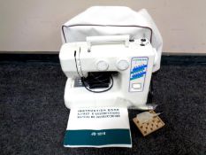 A Janome electric sewing machine with instructions