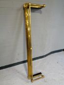 An antique brass fire fender