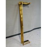 An antique brass fire fender