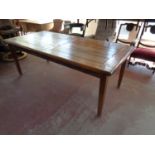 A contemporary hardwood pull out dining table fitted a leaf