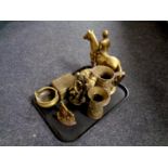 A tray containing antique and later brass ware to include embossed jugs, figure of horse and jockey,