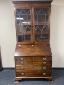 An early 19th century mahogany bureau bookcase on bracket feet