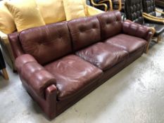 A twentieth century Continental three seater settee in Burgundy leather upholstery