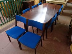 A 20th century oval extending dining table with leaf together with a set of eight matching chairs
