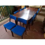 A 20th century oval extending dining table with leaf together with a set of eight matching chairs