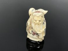 A carved Chinese netsuke - Bearded man with sack on his back