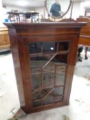 A 19th century mahogany hanging corner cabinet with astragal glazed doors