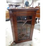 A 19th century mahogany hanging corner cabinet with astragal glazed doors