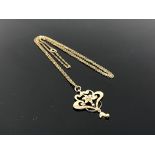 An antique 9ct gold pendant suspended on chain