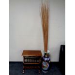 A Japanese vase containing reeds together with a reproduction mahogany magazine rack