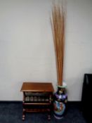 A Japanese vase containing reeds together with a reproduction mahogany magazine rack