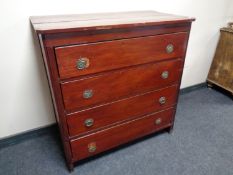 An antique pine stained four drawer chest