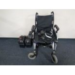 An electric wheelchair with batteries and charger