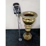 An ornate brass planter together with a shooting stick