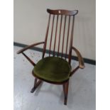 An Ercol solid elm and beech high back rocking chair in an antique finish