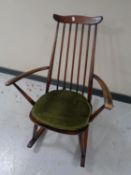 An Ercol solid elm and beech high back rocking chair in an antique finish