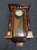 An Edwardian eight day wall clock with pendulum and key