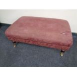 A Victorian style over sized footstool upholstered in a purple floral fabric (as found)