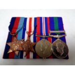 A group of four WWII medals to include campaign medal, Palestine Medal,