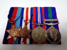 A group of four WWII medals to include campaign medal, Palestine Medal,