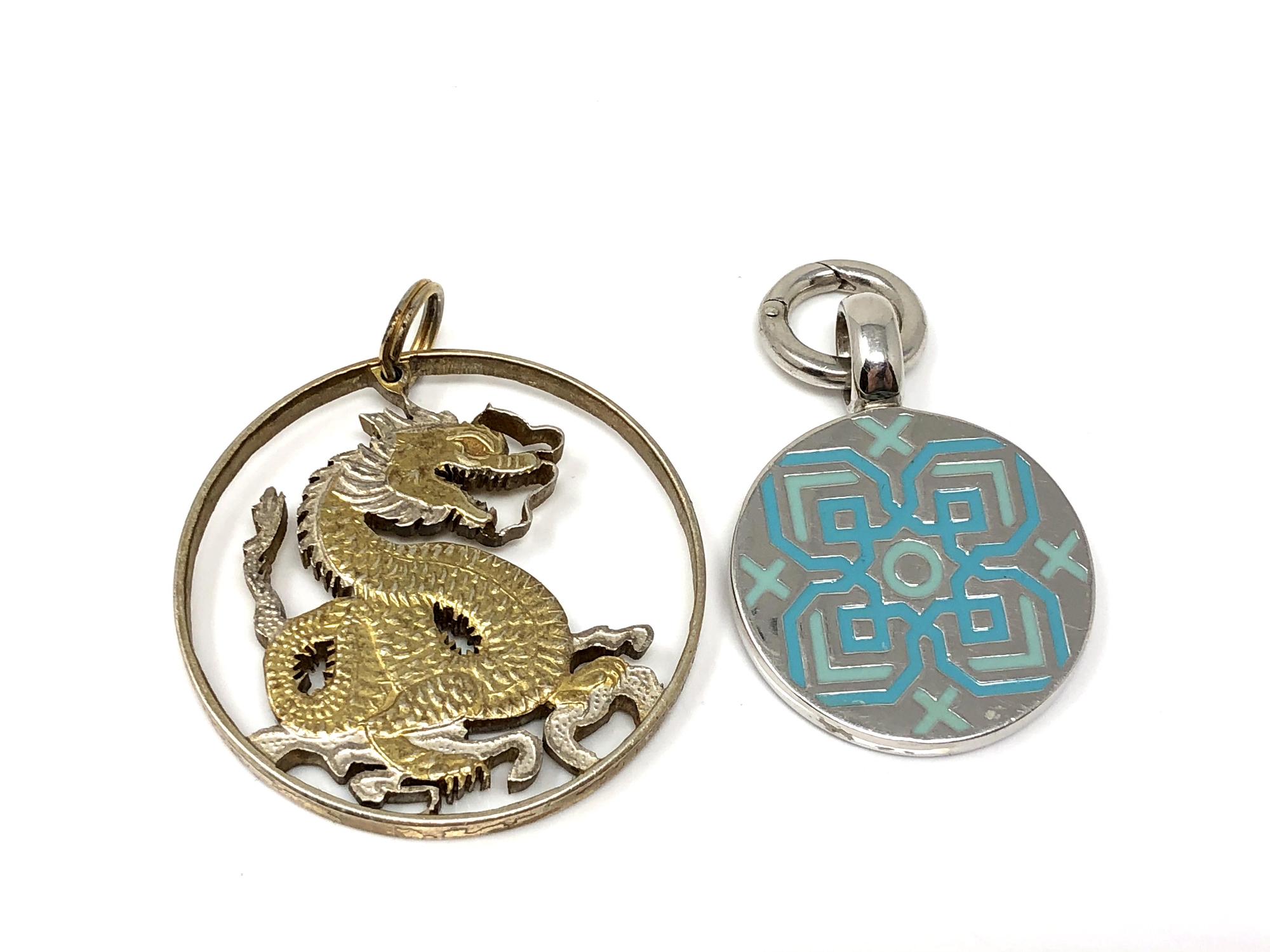 A sterling silver and enamel pendant together with a fine silver gilt pendant.