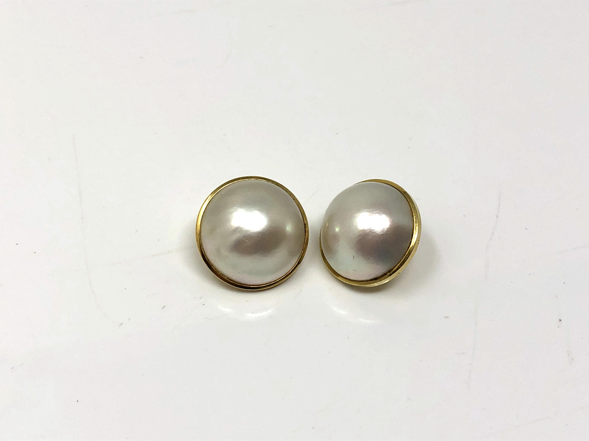 A pair of yellow gold mounted mabe pearl earrings CONDITION REPORT: One lacks post