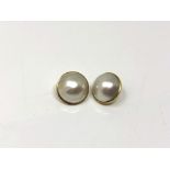 A pair of yellow gold mounted mabe pearl earrings CONDITION REPORT: One lacks post