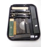 A tray containing cut throat razors, Rabone folding wooden ruler, a slide rule in case,