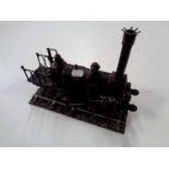A metal model of a 19th century steam engine on track