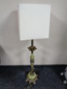 A brass and onyx effect figural table lamp with shade