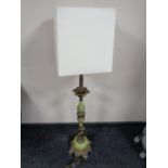 A brass and onyx effect figural table lamp with shade