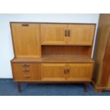 A mid 20th century teak G Plan cocktail sideboard on raised legs