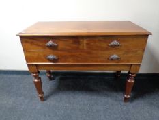 A Victorian three drawer serving table on raised legs