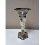 A loaded silver hexagonal pierced rimmed vase,