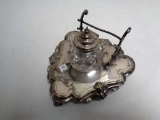 A silver plated ink stand with cut glass and silver plated inkwell