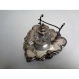 A silver plated ink stand with cut glass and silver plated inkwell