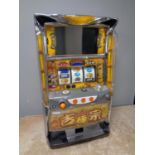 A Japanese table top electric fruit machine with key