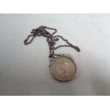 An 1899 silver dollar in mount on chain