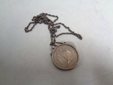 An 1899 silver dollar in mount on chain