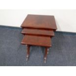 A nest of three Regency style tables on brass paw feet