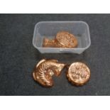 A box containing four copper jelly moulds