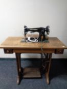 A Singer treadle sewing machine in oak table