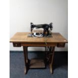 A Singer treadle sewing machine in oak table