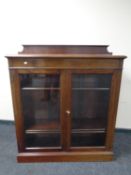 A 19th century mahogany glazed double door bookcase