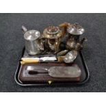 A tray containing three plated teapots together with a large silver plated serving spoon and ladle,