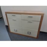A pine effect high gloss fronted eight drawer chest