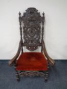 A 19th century heavily carved oak throne armchair