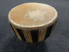 An African hide upholstered hand drum