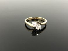 A 14ct gold two stone CZ crossover ring, size P CONDITION REPORT: 2.